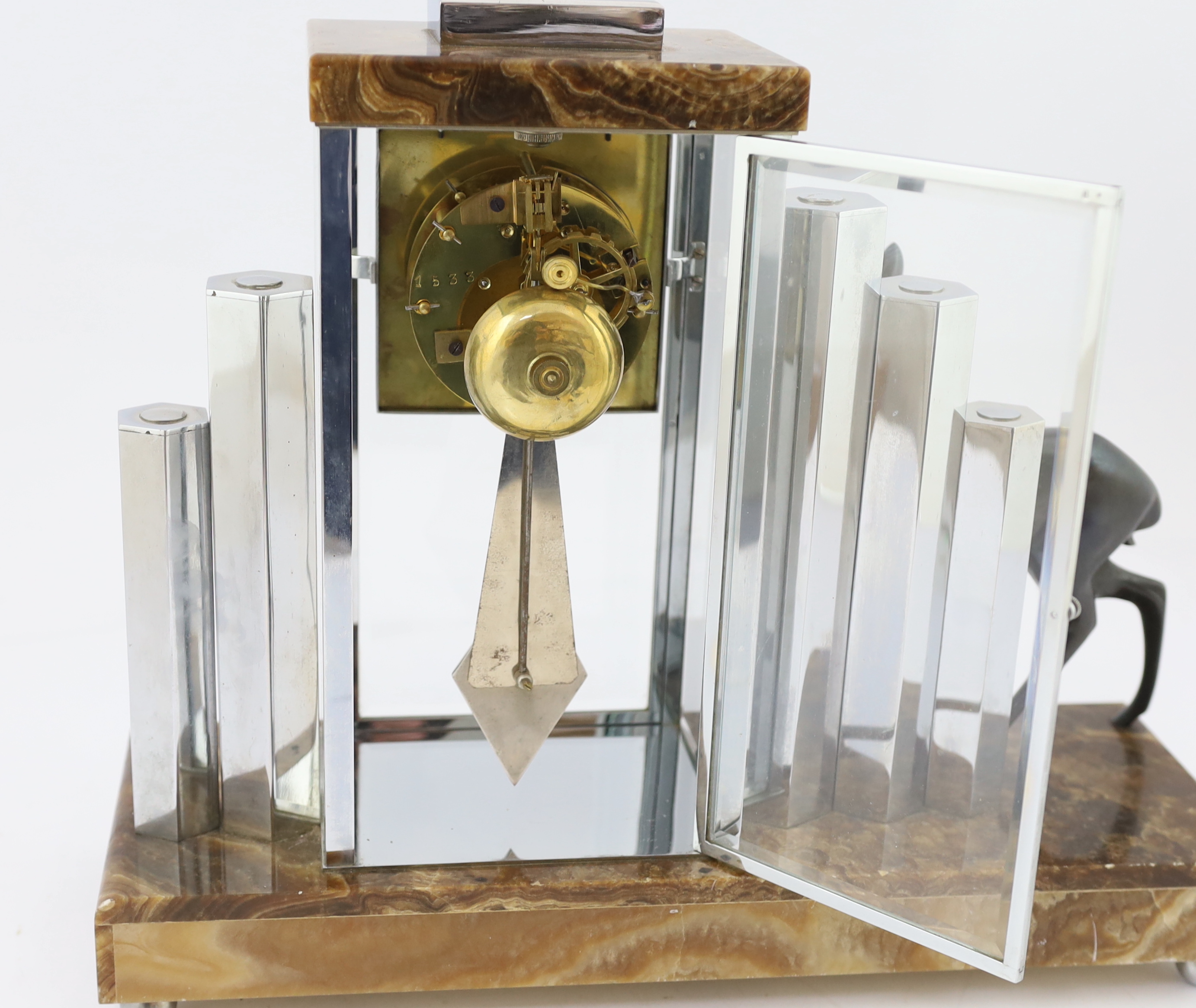 Attributed to Michel Decoux, a French Art Deco chrome and marble clock garniture, clock 42cm wide, 35cm high lamps 13.5cm wide, 26.5cm high